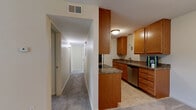 Located at 223 Markwell Ct in Louisville, KY, this single-floor, 2-bedroom, 1-bathroom home offers a practical and well-organized layout. The galley-style kitchen is a functional highlight, featuring warm honey-toned wood cabinetry, dark granite-style countertops, tile flooring, and a full suite of stainless steel appliances including a refrigerator, electric range, microwave, and dishwasher. A peninsula counter provides additional workspace and opens toward the hallway. A dedicated pantry adds convenient storage just off the kitchen. The hallway connects the living spaces efficiently, with carpet underfoot leading to both bedrooms. The primary bedroom offers a comfortable footprint with a window for natural light and a double-door closet. The second bedroom is similarly appointed with carpet, neutral walls, a window with outdoor views, and closet access. Throughout the home, an impressive six closets provide generous storage. The full bathroom features tile flooring, a tiled tub-and-shower combination, and brushed nickel fixtures. Neutral, warm beige tones carry throughout the home, creating a cohesive and calm ambiance. The living room rounds out the layout, completing this efficiently designed and move-in ready home.
