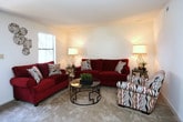 This 2-bedroom, 1-bathroom single-floor residence offers a thoughtfully arranged layout that balances comfort and functionality. The living area serves as the heart of the home, featuring a textured ceiling and neutral warm-toned walls that create a welcoming ambiance. A large window with blinds allows natural light to filter into the space, brightening the room throughout the day. The living room provides ample space for seating arrangements and social gatherings, complemented by stylish floor lamps that add a warm glow in the evenings. The overall design aesthetic blends classic and contemporary elements, with coordinating furnishings that highlight the room's versatility. The two bedrooms offer comfortable retreats, while the full bathroom provides all essential amenities. The single-floor layout ensures ease of movement and accessibility throughout the residence. Neutral flooring ties the spaces together cohesively, and the open feel of the main living area makes the home feel spacious and airy. This residence is an ideal space for those seeking a practical yet inviting home with a cozy and well-appointed interior.
