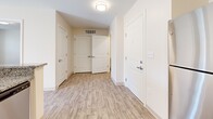 Located at 2000 NE Coronado Dr in Blue Springs, MO, this single-floor, 3-bedroom, 1-bathroom unit offers a functional and well-appointed layout. The kitchen is a standout feature, equipped with stainless steel appliances including a refrigerator, range, and dishwasher, complemented by granite countertops and crisp white shaker cabinetry. Wood-look vinyl flooring runs through the kitchen and entry areas, while plush carpet covers the living and bedroom spaces. The kitchen opens seamlessly to the living area, which is brightened by French doors that invite natural light and provide outdoor views. A welcoming entryway with light wood-look flooring connects the main rooms, offering convenient access to all three bedrooms and the bathroom. Each bedroom features soft carpeting, neutral walls, and ample closet space with double-door closets. The spacious primary bedroom includes direct access to the full bathroom. The bathroom is outfitted with a granite-top vanity, white cabinetry, and wood-look tile flooring. Additional conveniences include an in-unit laundry area. Throughout, the unit maintains a clean, neutral palette, creating a bright and move-in-ready atmosphere.