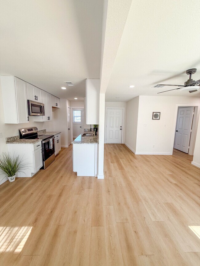 Cocina con electrodomésticos de acero inoxidable que conduce a lavadero independiente. - 308 E Bourn St