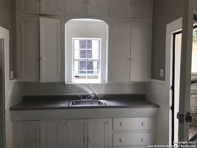 Cozy and full of character kitchen. The door leads to the specious back yard. - 217 Rigsby Ave