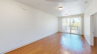 Located at 20750 Sherman Way in Winnetka, CA, this single-floor, one-bedroom, one-bathroom unit offers a practical and comfortable layout with consistent warm-toned hardwood-style flooring throughout. The open living area is bright and inviting, featuring large sliding glass doors that lead to a private balcony overlooking lush greenery, allowing natural light to fill the space. Clean white walls and flush-mount ceiling lighting create a simple, modern aesthetic throughout.

The kitchen is efficiently designed in an L-shaped configuration, equipped with light wood cabinetry, granite-style countertops, a full-size refrigerator, an electric range, a dishwasher, and a double sink — providing ample functionality for everyday cooking.

The bedroom is a well-proportioned private retreat with a window framing views of mature palm trees and surrounding greenery, adding a touch of California character to the room.

The bathroom is thoughtfully designed with accessibility in mind, featuring grab bars near the toilet and along the bathtub, a combination tub-shower with tiled surround, a wall-mounted sink, and matching hardwood-style flooring that ties the unit together. Overall, this unit offers a clean, functional living environment in a residential Winnetka neighborhood.