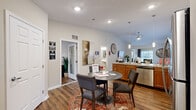 This well-appointed single-story residence in Orrville, Ohio offers a functional and comfortable layout across one generously sized floor, encompassing one bedroom, two bathrooms, a dedicated office, and an in-unit laundry room. The open-concept kitchen and living area forms the heart of the home, featuring warm wood cabinetry, granite-style countertops, stainless steel appliances including a range, microwave, dishwasher, and refrigerator, all set atop durable hardwood-style flooring. A dedicated dining area with pendant lighting flows naturally between the kitchen and living room, which is brightened by large windows and fitted with ceiling fans for year-round comfort. The spacious primary bedroom offers plush carpeting, multiple windows with natural light, a ceiling fan, and a generous walk-in closet with built-in shelving. Both bathrooms are well-sized, with one featuring accessibility grab bars and a tub/shower combination with hardwood-style flooring. The dedicated office provides ample space for a full workstation and is lit by a ceiling fan and natural light. The in-unit laundry room includes overhead cabinetry for added storage. Throughout the home, a neutral color palette, recessed lighting, and consistent finishes create a cohesive and inviting atmosphere.