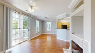 Located at 105 King Farm Blvd in Rockville, MD, this well-appointed single-floor home offers three bedrooms, three bathrooms, and a thoughtfully designed layout. The open-concept living and dining area is a standout, featuring warm hardwood flooring, crown molding, a ceiling fan, and a tile-surround fireplace. Large sliding glass doors flood the space with natural light and provide direct access to a private outdoor balcony. The kitchen is open to the living area and is equipped with light wood cabinetry, dark granite-style countertops, black appliances including a gas range, microwave, refrigerator, and dishwasher, and easy-care tile flooring. The three bedrooms are carpeted for comfort, each with ceiling fans and neutral wall tones. The primary bedroom is a generous size, complete with a closet and private bathroom access. The additional bedrooms offer ample space and natural light through well-placed windows. The three bathrooms are clean and functional, each featuring wood-toned vanities, tile flooring, and tub-shower combinations with white tile surrounds. Two closets provide convenient storage throughout the home. The overall ambiance is bright, neutral, and move-in ready.