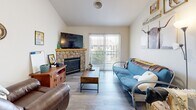 Located at 2226 W Elizabeth St in Fort Collins, CO, this 2-bedroom, 2-bathroom single-floor unit offers a well-designed layout across a comfortable footprint. Light-toned wood-style flooring runs throughout, lending a cohesive, clean aesthetic to every room.

The living room is a standout space, anchored by a stone-surround gas fireplace with a warm wood mantel. A sliding glass door fills the room with natural light and provides access to an outdoor area. The kitchen is open and functional, featuring light wood cabinetry, laminate countertops, and a full suite of white appliances including a range, microwave, dishwasher, and refrigerator. A peninsula with bar seating connects the kitchen to the dining area, which comfortably accommodates a round table and chairs.

Both bedrooms are well-proportioned, with the primary offering a cozy, private retreat. Each room features light walls and wood-style flooring. The second bedroom includes a sliding closet and a window that brings in natural light. The two bathrooms are clean and straightforward, each featuring a tub-shower combination. A dedicated laundry area houses a full-size washer and dryer, adding everyday convenience. The unit provides a practical and comfortable living environment in a desirable Fort Collins location.