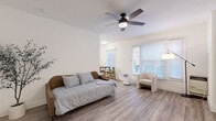 Located on Franklin Avenue in the heart of Hollywood, Los Angeles, this efficiently designed unit offers a well-organized layout across a single floor. The bright, open living area serves as the centerpiece of the space, featuring light wood-tone flooring, crisp white walls, and a ceiling fan with integrated lighting. Large windows fitted with horizontal blinds allow generous natural light to fill the room, creating an airy and welcoming atmosphere. A dedicated dining nook sits adjacent to the living area, making the most of the available footprint.

The galley-style kitchen is thoughtfully laid out, offering white cabinetry, a double-basin sink with light stone-toned countertops, a gas range, and a full-size refrigerator. A window above the dining area keeps the kitchen feeling open and bright. Light wood flooring continues throughout, tying the spaces together cohesively.

The bathroom is clean and minimal, featuring a white vanity with storage, a round mirror with a black frame, and a tub-shower combination. The closet provides dedicated storage to keep the living areas organized. The overall aesthetic is modern and neutral, with consistent white tones and natural wood elements lending a calm, understated character to the entire unit.