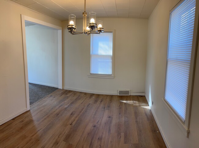 Dining room with new modern lighting attached to kitchen and opens into living room - 144 Coolidge St