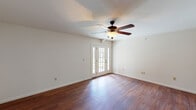 Located at 7278 Norwood Ct 2 in Norwood Court, Missouri, this single-floor residence offers a well-organized layout with a clean, neutral aesthetic throughout. Rich, dark hardwood-style flooring flows consistently across the main living areas and bedrooms, lending warmth and visual continuity to the space.

The main living area is spacious and bright, featuring a ceiling fan with a light fixture and elegant French doors that invite natural light and provide direct outdoor access. The open feel of this room makes it a versatile and welcoming centerpiece of the home.

The kitchen is outfitted with dark espresso-toned cabinetry, stone-patterned countertops, a stainless steel sink with a matte black faucet, and a dishwasher, providing both functionality and a cohesive design aesthetic.

The bedrooms continue the hardwood-style flooring and are each equipped with ceiling fans. The primary bedroom features dual closets and direct access to a private bathroom, offering added convenience. Additional bedrooms are served by windows that bring in natural outdoor views and ample daylight.

The bathroom presents a clean, functional design with neutral tile flooring, a vanity with dark cabinetry, and matte black hardware accents. Throughout the home, white walls and consistent finishes create a bright, move-in-ready environment.