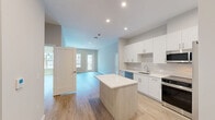 This well-appointed two-bedroom, two-bathroom residence at 303 Lincoln St, Unit 211 in Marlborough, MA offers a thoughtfully designed layout with modern finishes throughout. Light wood-tone flooring flows seamlessly across the entire unit, creating a cohesive and contemporary feel.

The open-concept kitchen and living area serves as the heart of the home, featuring crisp white cabinetry, a subway tile backsplash, stainless steel appliances, and a central island with additional seating and storage. Recessed lighting illuminates the space, while direct access to a private balcony brings in natural light and offers views of the resort-style pool courtyard below.

The spacious primary bedroom provides a generous retreat with large windows overlooking the community, complemented by a dedicated closet fitted with wire shelving systems for organized storage. The second bedroom is bright and airy, with its own closet and ample natural light. Both bathrooms are clean and modern — one features a walk-in glass-door shower with grab bars, while the other includes a full soaking tub and shower combination.

The living room opens directly to the balcony through a glass-paneled door, offering picturesque views of the beautifully landscaped pool area and surrounding building architecture, enhancing the overall sense of community and outdoor connectivity.