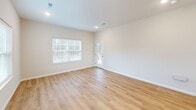 Located at 1352 Town Square Dr in Kent, Ohio, this efficiently designed one-bedroom, one-bathroom home offers a well-organized single-floor layout. The open-concept living, dining, and kitchen area forms the heart of the home, bathed in natural light from multiple windows with clean white blinds. Light-toned hardwood-style flooring runs throughout the main living spaces, lending a bright and cohesive feel.

The kitchen is a standout feature, equipped with white shaker cabinetry, white quartz countertops, a subway tile backsplash, and a full suite of stainless steel appliances including a gas range, microwave, refrigerator, and dishwasher. A central island with a built-in sink and pendant lighting above provides additional prep space and casual dining potential.

The bedroom is generously sized and connects to a walk-in closet outfitted with wire shelving systems for organized storage. Two additional closets provide ample storage throughout the home. A dedicated laundry area and utility room add everyday convenience.

The attached garage features a paneled overhead door with transom windows, offering secure parking and additional storage. A private patio extends the living space outdoors. The home's neutral color palette, recessed lighting, and clean finishes throughout create a move-in-ready environment well-suited for comfortable single-level living.