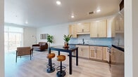 This well-appointed one-bedroom, one-bathroom unit at 28 Seventh St NE in Rochester, MN offers a thoughtfully designed single-floor layout. The open-concept living and kitchen area serves as the heart of the home, featuring light maple cabinetry, striking dark granite countertops, a geometric hexagonal tile backsplash, and a full suite of stainless steel appliances including a range, microwave, and dishwasher. Light luxury vinyl plank flooring runs throughout the main living areas, enhancing the bright, contemporary aesthetic. The living room is bathed in natural light through a large sliding glass door that opens to a private balcony with outdoor views, creating a seamless indoor-outdoor connection. The bedroom offers plush carpeting, a generous window with neighborhood views, and direct access to a walk-in closet with wire shelving for ample storage. The bathroom mirrors the kitchen's design language, featuring matching light maple cabinetry, dark granite countertops, a rectangular undermount sink, and matte black fixtures. Recessed lighting throughout and crisp white walls contribute to the clean, modern ambiance of this efficiently designed Rochester residence.