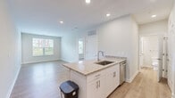 Located at 1330 Nashville Pike in Gallatin, Tennessee, this single-floor, 2-bedroom, 1-bathroom residence offers a thoughtfully designed layout with modern finishes throughout. Light-toned luxury vinyl plank flooring runs continuously through every room, creating a clean, cohesive aesthetic.

The combined kitchen and living area serves as the heart of the home. The kitchen features white shaker-style cabinetry, granite countertops, stainless steel appliances including a refrigerator, range, microwave, and dishwasher, and a peninsula with a undermount sink — ideal for both meal preparation and casual dining. Recessed lighting illuminates the space effectively.

Both bedrooms are well-sized, with the primary bedroom offering a ceiling fan and direct access to adjacent rooms. Each bedroom benefits from natural light through window blinds, with views of the surrounding greenery and neighborhood. One bedroom also connects to a dedicated closet.

The full bathroom is finished with white subway tile in the tub/shower surround, a white vanity with granite countertops, and brushed nickel hardware, delivering a clean, contemporary feel.

Throughout the residence, neutral wall tones, clean white trim, and consistent flooring provide a bright and move-in-ready environment suited for comfortable everyday living.