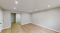 Located at 319 Columbia Ave in Stratford, NJ, this efficiently designed one-bedroom, one-bathroom unit offers a clean, modern aesthetic with quality finishes throughout its single floor. Light wood laminate flooring runs seamlessly through every room, complementing the neutral warm-gray walls and crisp white trim for a cohesive and contemporary look.

The living room is bright and open, featuring recessed lighting, a front entry door with a glass panel, and windows that allow natural light to fill the space. Baseboard heating is present throughout, ensuring year-round comfort.

The kitchen is well-appointed with white shaker-style cabinetry, light countertops, a classic subway tile backsplash, and a full suite of stainless steel appliances including a refrigerator, electric range, and over-the-range microwave.

The bedroom offers a comfortable footprint with a large window for natural light, a baseboard heater, and a double sliding-door closet for ample storage. A hallway connects the rooms cleanly, maintaining a functional and organized layout.

The bathroom features light gray tile flooring and wall surround, a white soaking tub with shower, a vanity with cabinet storage, and matte black fixtures that add a modern contrast. Overall, this unit presents a fresh, move-in-ready living space with updated finishes and a practical floor plan.