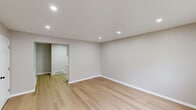 Located at 319 Columbia Ave in Stratford, NJ, this efficiently designed one-bedroom, one-bathroom unit offers a clean, modern aesthetic with quality finishes throughout its single floor. Light wood laminate flooring runs seamlessly through every room, complementing the neutral warm-gray walls and crisp white trim for a cohesive and contemporary look.

The living room is bright and open, featuring recessed lighting, a front entry door with a glass panel, and windows that allow natural light to fill the space. Baseboard heating is present throughout, ensuring year-round comfort.

The kitchen is well-appointed with white shaker-style cabinetry, light countertops, a classic subway tile backsplash, and a full suite of stainless steel appliances including a refrigerator, electric range, and over-the-range microwave.

The bedroom offers a comfortable footprint with a large window for natural light, a baseboard heater, and a double sliding-door closet for ample storage. A hallway connects the rooms cleanly, maintaining a functional and organized layout.

The bathroom features light gray tile flooring and wall surround, a white soaking tub with shower, a vanity with cabinet storage, and matte black fixtures that add a modern contrast. Overall, this unit presents a fresh, move-in-ready living space with updated finishes and a practical floor plan.