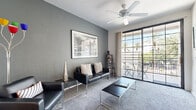 Located at 3411 N 16th St in Phoenix, Arizona, this single-floor residence offers a thoughtfully designed layout with a cohesive modern aesthetic throughout. The living room is anchored by cool gray walls, plush carpeting, and a ceiling fan, creating a comfortable and stylish gathering space. Large sliding glass doors lead to a private balcony with views of mature palm trees, filling the room with natural light. The galley-style kitchen features light wood cabinetry, dark countertops, wood-look flooring, and white appliances, with the added convenience of an in-unit washer and dryer tucked just beyond. Adjacent to the kitchen, the dining area provides a casual space for meals, highlighted by wood-look flooring and direct views toward the main living area. The bedroom is a serene retreat with soft carpeting, generous natural light from large windows with vertical blinds, and ample room for storage. The bathroom is well-appointed with a wide vanity featuring dark countertops, wood-look flooring, and a full tub-shower combination. Throughout the residence, a consistent use of framed wall art and clean, neutral finishes lends a polished and inviting atmosphere.