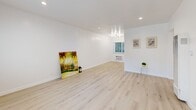 This recently renovated apartment offers a bright and airy living space with 730 square feet of thoughtfully designed interiors. The open-concept layout maximizes the use of space, creating a seamless flow between rooms. Light wood flooring runs throughout, complementing the crisp white walls and adding warmth to the space.

The living room is spacious and filled with natural light from large windows, offering a perfect setting for relaxation or entertaining. The kitchen, while compact, is efficiently designed with sleek white cabinetry, modern appliances, and ample counter space for meal preparation.

The primary bedroom, measuring 150 square feet, provides a comfortable retreat with closet space and room for a queen-sized bed. The second bedroom, while smaller, is versatile and could serve as a guest room or home office. Both bathrooms feature modern fixtures, with one boasting an elegant marble-tiled shower surround.

Recessed lighting throughout enhances the apartment's contemporary feel, while strategically placed windows allow for plenty of natural light. The property's single-floor layout ensures easy accessibility, making it an ideal choice for various lifestyles. Located in Los Angeles, this apartment combines urban convenience with a fresh, modern aesthetic.