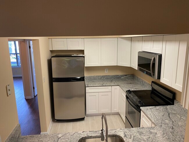 Kitchen with granite countertops & stainless steel appliances - 13636 Orchard Dr