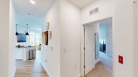 Located at 13 Buckingham St in Morganville, NJ, this well-appointed 2-bedroom, 2-bathroom single-floor home offers a thoughtfully designed open-concept layout that maximizes comfort and functionality. Light hardwood flooring flows throughout the main living areas, creating a warm and cohesive aesthetic.

The kitchen is a standout feature, showcasing crisp white cabinetry, dark stone countertops, a herringbone tile backsplash, stainless steel appliances, and pendant lighting. It connects seamlessly to the dining area, which is bathed in natural light from large sliding glass doors that open onto a private balcony overlooking a green outdoor setting.

The living room is bright and airy, with oversized windows fitted with roller shades that invite generous natural light while maintaining privacy. A dedicated sitting nook adds versatility to the living space.

The generously sized primary bedroom features plush carpeting, a ceiling fan, wide windows with outdoor views, and ample closet space. The second bedroom is equally comfortable and well-proportioned. Both bathrooms are clean and modern, with one featuring a full soaking tub with tiled surround and dark stone vanity countertops.

A central hallway connects all rooms efficiently, completing this cohesive and move-in-ready home.