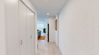 Located at 909 E Michigan St in Milwaukee, this thoughtfully designed 2-bedroom, 2-bathroom residence offers a bright, contemporary living experience across a well-appointed single floor. Light wood flooring flows throughout, complementing the clean white walls and modern aesthetic.

The open-concept living area is a standout, anchored by expansive floor-to-ceiling windows that frame sweeping views of Lake Michigan and the Milwaukee skyline, flooding the space with natural light. A glass door leads to an outdoor balcony, seamlessly connecting interior and exterior. The kitchen features two-tone cabinetry in white and slate blue, stainless steel appliances, a large center island with white countertops, and recessed lighting overhead.

The primary bedroom is generously sized, offering direct access to the balcony through sliding glass doors and views of the waterfront. Both bathrooms are finished in crisp white subway tile with light wood flooring, modern vanities, and clean chrome fixtures — one featuring a soaking tub and the other a walk-in shower. A stacked in-unit washer and dryer adds everyday convenience. A dedicated closet and hallway with recessed lighting complete this well-organized, light-filled residence.
