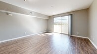 Located at 5395 Napa St in San Diego's 92110 zip code, this three-bedroom, two-bathroom residence offers a well-designed single-floor layout with contemporary finishes throughout. The open kitchen serves as a centerpiece, featuring white shaker cabinetry, a white subway tile backsplash, a quartz waterfall peninsula with an undermount sink, and a full suite of stainless steel appliances including a range, over-the-range microwave, dishwasher, and refrigerator. Hardwood-style flooring runs through the kitchen and living areas, lending warmth and visual continuity. The bright living room opens to a private balcony through sliding glass doors, offering sweeping city views and abundant natural light. The primary bedroom is a comfortable retreat with its own closet access. Two additional bedrooms are carpeted and filled with natural light from well-placed windows. Two closets provide generous storage. Both bathrooms are finished with white vanity cabinetry, marble-style countertops, and hardwood-style flooring; one includes a soaking tub and shower combination. A carpeted hallway connects the bedrooms to the shared living spaces, creating a practical and cohesive floor plan suited for everyday living in San Diego.