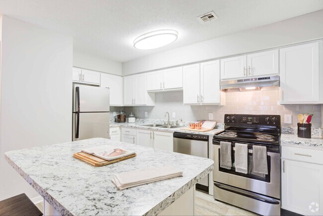 Kitchen with white cabinetry and stainless steel appliances - Avana Collins Creek