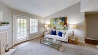Located at 3400 Cox Road in Richmond, VA, this well-appointed two-bedroom, two-bathroom residence offers a thoughtfully designed single-floor layout. The open kitchen is a standout feature, showcasing granite countertops, crisp white cabinetry, stainless steel appliances including a range, microwave, refrigerator, and dishwasher, and wood-look flooring that adds warmth and durability. The kitchen flows naturally into the combined living and dining area, where plush carpeting, neutral tones, and a glass door leading to the outdoors create a bright, welcoming atmosphere. Both bedrooms are carpeted and bathed in natural light from generously sized windows. The spacious primary bedroom includes a walk-in closet with wire shelving, providing ample storage. The second bedroom is equally comfortable, also featuring a dedicated closet. Both bathrooms are well-finished, with granite-topped vanities, white cabinetry, and tub-shower combinations outfitted with clean white tile surround. A dedicated in-unit laundry area with overhead shelving adds everyday convenience. A hallway connects all areas of the home efficiently, while two closets offer additional storage throughout. The overall aesthetic is clean, neutral, and move-in ready.