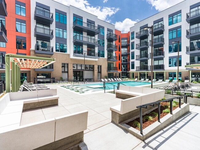 A fresh perspective on downtown leisure — unwind in the expansive pool courtyard, designed for comfort, connection, and a splash of sun. - Modera SoBro Apartments