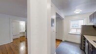 Located at 320 Avenue Rd in Toronto's desirable Summerhill neighbourhood, this compact unit offers a thoughtfully organized single-floor layout. The combined kitchen and living area serves as the heart of the space, where warm hardwood floors and crisp white walls create a clean, inviting atmosphere. Large windows allow natural light to pour in, offering views of the surrounding brick streetscape and keeping the space feeling open and airy. A classic cast-iron radiator adds a charming, period-appropriate touch to the living area. The kitchen features slate-grey tile flooring, white trim detailing, and a bright window that brings in additional natural light, complemented by a stainless steel refrigerator. Two hallways connect the unit's spaces efficiently, maintaining a smooth flow throughout. The bathroom is well-appointed with a full soaker tub and shower combination, horizontally laid beige tile surround, and a frosted window for natural light and privacy. Throughout the unit, white baseboards and trim provide a consistent, polished finish. This space is ideal for those seeking a functional, character-filled home in one of Toronto's most sought-after central neighbourhoods.