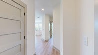 Located at 2000 Aspen Way in Franklin, Tennessee, this well-appointed 2-bedroom, 2-bathroom residence offers a thoughtfully designed open-concept layout with a bright, contemporary aesthetic. Light wood flooring flows consistently throughout the space, complementing the clean white walls and modern finishes.

The kitchen and living area form a seamless, open hub of the home. The kitchen features white shaker-style cabinetry, stainless steel appliances, a center island with a sink, and light countertops, all illuminated by recessed lighting and natural light from multiple windows.

The primary bedroom is generously sized, boasting a bank of large windows that invite ample sunlight and outdoor views, along with a ceiling fan and a dedicated walk-in closet. The second bedroom mirrors the same bright, airy character with its own ceiling fan and large window. Both rooms feature the same warm wood-tone flooring.

The two bathrooms are finished in a crisp white palette with distinctive dark hardware accents. The primary bath includes a glass-enclosed walk-in shower with white subway tile, while the second bath offers a tiled tub-shower combo with a curved rod and matching fixtures. Three closets provide generous storage throughout the residence.