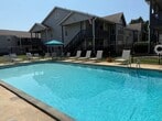 This 840 square foot apartment in Decatur offers a well-designed living space on a single floor. The layout includes one bedroom, measuring 180 square feet, and two full bathrooms, providing convenience and privacy. The heart of the home is an open-concept kitchen and living room area, ideal for entertaining or relaxation.

The kitchen is equipped with white appliances and features a practical galley-style design with ample counter space and storage. Two-toned cabinetry in cream and wood finishes adds visual interest. Throughout the apartment, wood-look flooring creates a cohesive and modern aesthetic.

Large windows in the living area and bedroom allow for natural light, potentially offering views of the nearby harbor. The primary bedroom is spacious and includes a closet for storage. Both bathrooms feature single vanities with under-sink storage.

Additional storage is provided by two closets and a hallway, enhancing the apartment's functionality. The neutral color palette of whites and soft grays creates a bright, airy atmosphere that can easily accommodate various decorating styles.

Located at 1050 Harborview Dr NE in Decatur, this apartment combines efficiency with comfort, making it an attractive option for those seeking a modern living space in a potentially scenic location.