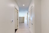Located at 46 Soldiers Field Place in Boston, MA, this thoughtfully designed single-floor unit offers a clean, contemporary aesthetic throughout. Light-toned hardwood flooring runs continuously across the space, complementing the crisp white walls and recessed lighting that keep the interior bright and welcoming.

A wide hallway entrance provides access to the various areas of the unit, with louvered closet doors offering convenient built-in storage. The open-concept layout seamlessly integrates the kitchen, dining, and living areas into one cohesive space. The kitchen is outfitted with tall white shaker cabinetry, a full suite of stainless steel appliances including a refrigerator, range, microwave, and dishwasher, and a light-toned countertop. A large window in the living and kitchen area floods the space with natural light and offers views of the surrounding Boston neighborhood.

The bathroom features a sleek, modern design with large-format dark tile flooring, a glass-enclosed walk-in shower finished with classic white subway tile, and a floating vanity with a white countertop and a frameless mirror above. In-unit laundry adds a practical convenience, while two dedicated closets provide ample storage throughout the home.