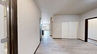 Located at 6274 Portal Way in Ferndale, Washington, this well-appointed 2-bedroom, 2-bathroom residence offers a thoughtfully designed single-level layout with modern finishes throughout. The open-concept living area features light wood-look flooring that flows seamlessly into the kitchen, where dark espresso cabinetry is paired with a white quartz island, subway tile backsplash, and a full suite of stainless steel appliances. A sliding glass door in the living area provides access to a private balcony and brings in natural light. Both bedrooms are carpeted and generously sized, with large windows offering neighborhood views. The spacious primary bedroom includes a walk-in closet outfitted with wire shelving for organized storage. The bathrooms are finished with dark-toned vanities and light vinyl plank flooring; one features a tub/shower combination with matte black fixtures. A dedicated in-unit laundry area with a stacked washer and dryer adds everyday convenience. The overall aesthetic is clean and contemporary, with neutral tones, dark wood trim accents, and recessed lighting creating a cohesive and comfortable living environment.
