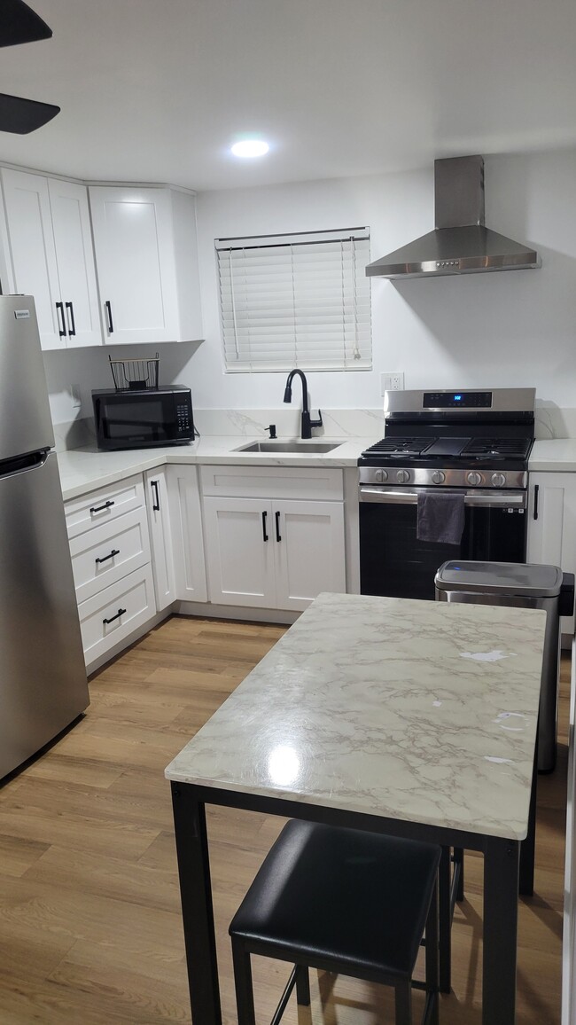 Kitchen area with full size fridge and stove, softclose cabinets - 1274 N Hamilton Blvd