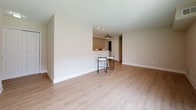 Located at 146 Chestnut Crossing Rd in Newark, Delaware, this single-floor residence offers a clean, modern aesthetic with a neutral color palette throughout. The open living and dining area is finished with light wood-style flooring and features a sliding glass door with vertical blinds that invites natural light and provides access to the outdoors. A pass-through counter connects the living space to the kitchen, which is equipped with dark wood-toned cabinetry, white appliances including a gas range, microwave, refrigerator, and sink, all set atop light countertops and complemented by a ceiling fan with recessed lighting nearby. The bedrooms are carpeted in a warm beige tone and each is naturally lit by windows with blinds, creating a comfortable and restful atmosphere. The bathrooms are finished with light tile flooring and feature clean white fixtures, modern brushed hardware for towel bars and toilet paper holders, and white vanity cabinetry with medicine cabinet storage. Consistent warm beige wall tones and crisp white trim and doors tie the entire space together, creating a cohesive and well-maintained interior suited for comfortable everyday living.