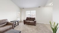 Located at 307 Towne Dr in Elizabethtown, Kentucky, this well-appointed 2-bedroom, 2-bathroom unit offers a thoughtfully designed single-floor layout. The living room features plush carpeting, neutral walls, and natural light streaming through a windowed door, creating a warm and inviting atmosphere. The kitchen is a standout space, showcasing crisp white shaker-style cabinetry, light wood-tone flooring, and a full suite of stainless steel appliances including a refrigerator, dishwasher, range, and microwave. Light countertops and ample cabinet storage make this kitchen both functional and visually clean. The primary bedroom offers comfortable carpeted flooring, a dedicated closet, and a natural light-filled window. The second bedroom mirrors this cozy, practical design. Both bathrooms are finished with white vanity cabinetry, light countertops, and wood-look tile flooring; one features a tub-shower combination. Two closets provide convenient storage throughout the home. The overall aesthetic is clean, modern, and neutral, offering a move-in-ready space with consistent finishes that balance practicality and comfort throughout.