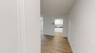 Located at 7-11 Rochefort Dr in Toronto's Don Mills neighbourhood, this well-appointed 2-bedroom, 1-bathroom unit offers a clean, modern aesthetic across a thoughtfully laid-out single floor. Light-toned hardwood flooring flows consistently throughout every room, creating a warm and cohesive feel.

The living areas are bright and open, benefiting from large windows that frame lush, tree-lined views and invite generous amounts of natural light. Baseboard heating runs along the walls, ensuring comfort year-round. The space connects fluidly to a galley-style kitchen, which is equipped with stainless steel appliances including a full-size refrigerator and electric range, complemented by white cabinetry and dark countertops.

The primary bedroom is a comfortable size, featuring a window overlooking the greenery outside, while the second bedroom offers a clean, versatile space with its own thermostat panel. Both rooms share the same warm hardwood flooring and crisp white walls that define the unit's overall aesthetic.

The bathroom is finished with white subway-style wall tiles and includes a full tub-shower combination with chrome fixtures. A connecting hallway ties all rooms together efficiently, adding to the unit's practical and functional layout. The overall ambiance is clean, bright, and move-in ready.