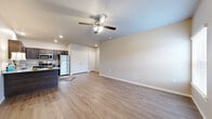 Located at 1441 E Omaha St in Broken Arrow, Oklahoma, this two-bedroom, one-bathroom single-floor unit offers a functional and modern layout designed for comfortable everyday living. The open-concept living, dining, and kitchen area forms the heart of the home, finished with light wood-look luxury vinyl plank flooring and neutral-toned walls that create a bright, welcoming atmosphere. Ceiling fans with integrated lighting are featured throughout the unit. The kitchen is well-appointed with dark espresso cabinetry, granite-look countertops, a peninsula breakfast bar, and a full suite of stainless steel appliances including a refrigerator, electric range, microwave, and dishwasher. A double-door closet in the main living area provides convenient additional storage. The two bedrooms are carpeted and each feature a ceiling fan and a window that allows in natural light. The primary bedroom connects to a closet and offers a comfortable, well-sized retreat. The shared bathroom includes a tub-shower combination with sliding glass doors, wood-toned cabinetry, and matching flooring. A hallway connects the living spaces to the bedrooms, completing the efficient and cohesive floor plan.