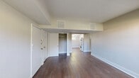This 3-bedroom, 1-bathroom apartment at 800 N Broad St in Elizabeth, NJ offers a well-organized single-floor layout with a thoughtful mix of finishes throughout. The living room makes a strong first impression with rich, dark hardwood flooring, neutral-toned walls, and natural light streaming in through a side window, creating a bright and open atmosphere. The kitchen is outfitted with white cabinetry, clean countertops, and stainless steel appliances including a full-size refrigerator and gas range, with light wood-tone flooring tying the space together. A standout feature of the primary bedroom is its generous proportions, open closet with built-in rod, and convenient in-unit stacked washer and dryer. The additional bedrooms are carpeted and feature white-encased radiators and windows that bring in natural greenery views from outside. The bathroom showcases elegant marble-style tile surrounding a full tub and shower combination, lending a refined touch to the space. Throughout the apartment, a consistent use of soft neutral paint tones, crisp white trim, and a mix of hardwood and carpet flooring creates a cohesive and clean aesthetic suitable for comfortable everyday living.