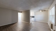 Located at 924 Quincy St in Fort Smith, Arkansas, this single-story, 2-bedroom, 1-bathroom home offers a practical and efficiently designed layout. The living room features durable wood-look laminate flooring, neutral gray walls, a textured ceiling, and a ceiling fan, creating a comfortable and functional common area. A front-facing window allows natural light to fill the space, and a dedicated entry door provides direct access.

The galley-style kitchen is well-equipped with white cabinetry extending to the ceiling, dark granite-style countertops, a dark tile backsplash, a white electric range, refrigerator, and a single-basin sink — offering ample storage and prep space for its size.

Both bedrooms are carpeted and include ceiling fans with light fixtures. The primary bedroom is a generous size and includes closet access. The second bedroom also features a window for natural light. A shared full bathroom includes a white vanity with dark countertop, a tiled tub/shower combination, and wood-look flooring. A separate laundry room houses the water heater and provides washer/dryer hookup connections, adding everyday convenience to this straightforward and functional home.