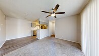 Located at 9860 Scyene Rd in Dallas, TX, this one-bedroom, one-bathroom unit is thoughtfully laid out across a single floor, offering a functional and comfortable living environment. The open-concept living and dining area is anchored by plush carpeting and a ceiling fan with a light fixture, creating a relaxed, airy atmosphere. Neutral-toned walls and a textured ceiling carry throughout the space, lending a clean and consistent aesthetic.

The kitchen is a standout feature, designed in a galley style with gray cabinetry accented by matte black hardware, white subway tile backsplash, and light wood-look vinyl flooring. Stainless steel appliances — including a refrigerator, dishwasher, and range — offer modern convenience, while the peninsula counter connects seamlessly to the dining area for easy entertaining.

The bedroom is a comfortable retreat, featuring soft carpet flooring, a window with natural light, and direct access to the bathroom and a closet. The bathroom includes a full tub/shower combo, a vanity with gray cabinetry, and ample overhead storage. Additional closet space and an in-unit laundry area round out the practical offerings of this well-appointed Dallas residence.