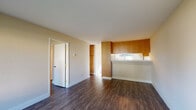 Located at 2118 Canoas Garden Ave in the Willow Glen area of San Jose, California, this single-floor residence offers a clean, functional layout with a cohesive design throughout. Dark hardwood-style flooring runs continuously across the living spaces, providing a warm and grounded aesthetic that ties the rooms together.

The open living area is bright and welcoming, with neutral beige walls and a pass-through kitchen counter that connects it to the kitchen. The kitchen is well-appointed with warm oak cabinetry, tile countertops, a stainless steel sink, and a full electric range with overhead ventilation. A window above the counter lets in natural light and offers a view of the outdoors.

The bedrooms are generously sized, each featuring large windows that frame views of the surrounding greenery, as well as baseboard heating. One bedroom includes a built-in closet with sliding doors, providing practical storage.

The bathroom features a wood-toned vanity with a tiled countertop, a dual-mirror setup, and brushed nickel fixtures and hardware, lending a tidy and well-maintained feel. The consistent use of hardwood-style flooring extends into this space as well.

Overall, the residence presents a practical and comfortable living environment with warm natural tones, ample natural light, and a straightforward single-level floor plan suited for everyday living.