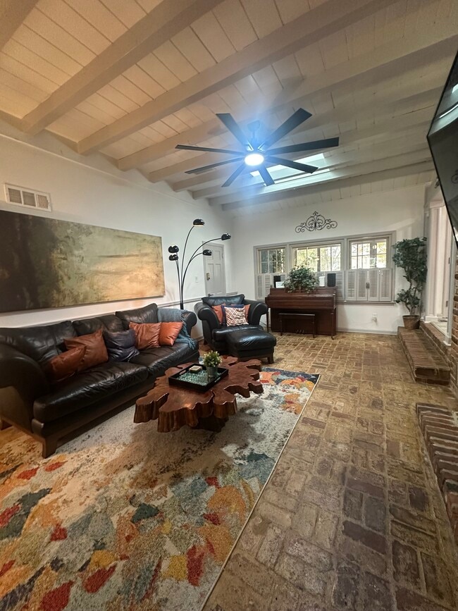 Rustic charm meets modern comfort — exposed brick, cool breeze, and a 60-inch view of relaxation. - 5460 Scofield Rd