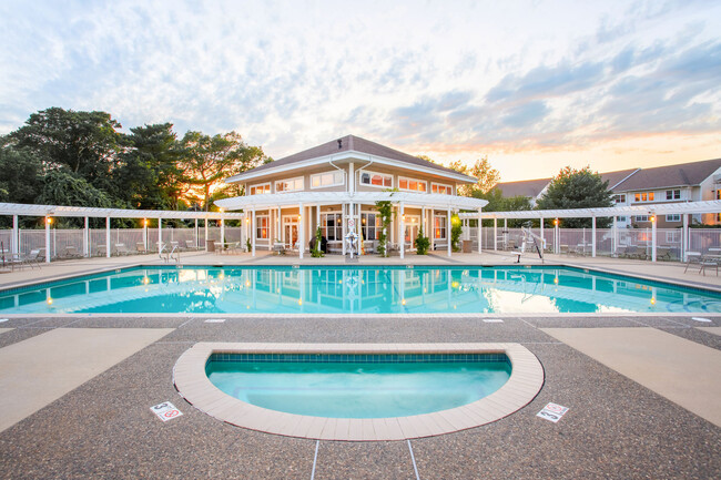 Resort-Style Pool with Pergola and Chaise Lounge Seating - Chestnut Farm Apartments