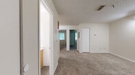 Located at 440 Meriden Rd in Waterbury, Connecticut, this 2-bedroom, 1-bathroom unit offers a well-organized single-floor layout designed for comfortable everyday living. The living area features plush carpeting, track lighting, and a textured ceiling, creating a welcoming entry point into the home. Each bedroom is carpeted and benefits from natural light streaming through white-blinded windows that frame views of surrounding greenery. The primary bedroom includes a ceiling fan with light fixture, providing added comfort and ventilation. The second bedroom features a built-in louvered closet, offering practical storage. The full bathroom is finished with wood-toned cabinetry, a single-sink vanity with ample counter space, and wood-look vinyl flooring, giving it a clean and functional aesthetic. The kitchen is well-appointed with warm oak cabinetry extending to the ceiling, light countertops, tile-style flooring, and white appliances including a range, dishwasher, and refrigerator, along with track lighting overhead. Throughout the unit, neutral tones and consistent finishes create a cohesive and move-in-ready atmosphere well-suited for a range of residents.