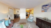 Located at 12423 East Mansfield Avenue in Spokane Valley, WA, this single-floor unit offers a practical and comfortable layout designed for everyday living. The open-concept living and dining area creates a seamless flow, with plush carpeting in the living space transitioning to durable wood-look flooring in the dining and kitchen areas. The living room is bright and welcoming, featuring a sliding glass door that invites natural light and provides direct outdoor access. The kitchen is well-appointed with warm oak cabinetry, light countertops, and stainless steel appliances including a gas range, over-the-range microwave, and refrigerator. A dedicated dining area sits adjacent to the kitchen, making the space ideal for both casual meals and entertaining. The unit includes two bedrooms, each with soft carpeting and windows that bring in natural light and outdoor views. One bedroom features a sliding closet with built-in shelving, while the other benefits from a corner window arrangement that enhances the sense of openness. The bathroom includes wood-look tile flooring, a vanity with ample cabinet storage, and a shower with a decorative curtain. Throughout, the neutral color palette and functional design provide a clean, move-in-ready environment.