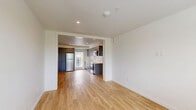 Located at 2365 NE Conners Ave in Bend, Oregon, this thoughtfully designed one-bedroom, one-bathroom unit offers a clean, modern aesthetic throughout its efficiently organized single-floor layout. Light hardwood flooring flows seamlessly through every room, complementing the crisp white walls and creating a bright, cohesive atmosphere.

The open-concept living and dining area connects directly to a well-appointed kitchen, which features sleek gray flat-front cabinetry extending to the ceiling for ample storage, white countertops, a subway tile backsplash, and a full suite of stainless steel appliances including a refrigerator, oven, microwave, and dishwasher. Natural light enters through a window adjacent to the kitchen's exterior door, which provides access to the private balcony.

The bedroom offers a comfortable, quiet retreat with two windows framing views of surrounding greenery, filling the room with natural light. A dedicated closet provides organized storage. The combined bathroom and laundry room features a full bathtub with shower, a window for ventilation and light, and clean white finishes. The unit's modern design, efficient use of space, and quality finishes make it a practical and attractive residence in Bend.