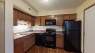 Located at 278 Silver Maple Dr in Delaware, Ohio, this two-floor home offers a practical and well-organized layout across both levels. The kitchen is a standout feature, equipped with warm-toned wood cabinetry offering generous storage, granite-style countertops, hardwood-style flooring, and a full suite of black appliances including a range, microwave, dishwasher, and refrigerator. A double-basin sink and under-cabinet lighting add to its functionality.

The living area on the main level features neutral carpet and is anchored by a staircase leading to the upper floor, with closet storage conveniently accessible nearby. The upper level hosts multiple carpeted bedrooms, each finished with neutral walls, textured ceilings, and blinds-covered windows that allow for natural light. Several bedrooms include closets, providing ample storage.

Two bathrooms serve the home, each featuring warm wood vanities with granite-style countertops and large mirrors. One bathroom includes a full tub/shower combination with chrome fixtures, while a second offers a vanity with additional towel storage. The consistent finishes throughout — including matching countertop surfaces in the kitchen and bathrooms — give the home a cohesive, well-maintained feel throughout both floors.