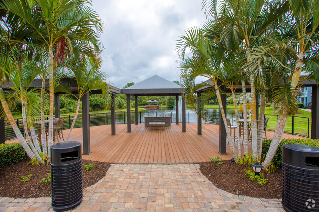 Audubon Village – Lakeside deck with gazebos and seating with a view of the lake. - Audubon Village