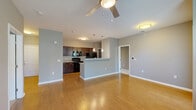 Located at 1380 Saylor Dr in Zionsville, Indiana, this single-floor residence offers a practical and comfortable layout with 2 bedrooms and 2 bathrooms. The open-concept living and kitchen area forms the heart of the home, featuring warm hardwood-style flooring, neutral gray walls, and a ceiling fan that enhances airflow and comfort. Natural light flows in through multiple windows, creating a bright and welcoming atmosphere.

The kitchen is well-equipped with rich dark cabinetry, granite-look countertops, black appliances including a range, built-in microwave, and refrigerator, complemented by a peninsula that provides additional prep space and a casual dining option. A pantry adds convenient storage.

Both bedrooms are carpeted and bathed in soft, neutral tones. The primary bedroom offers a generous footprint with a closet and direct access to its own bathroom. Each bathroom features a tub-shower combination, dark wood vanity with granite-style countertops, and hardwood-style flooring. One bathroom includes built-in shelving for added organization.

Additional highlights include three closets, a dedicated laundry area, a utility room, and an entry door with outdoor access to a balcony or patio. The thoughtful layout maximizes functionality throughout this Zionsville residence.