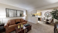 Located at 4121 Dale Rd in Modesto, CA, this single-floor residence offers a thoughtfully arranged layout with one bedroom, two bathrooms, a dedicated office, and a combined kitchen and living area. The living room is carpeted and bathed in natural light from a sliding glass door that opens to an outdoor patio, creating an inviting, airy atmosphere. A large decorative mirror anchors the main wall, enhancing the sense of space. Adjacent to the living area, the kitchen features warm oak cabinetry, ample upper and lower storage, a white countertop with an integrated sink, a dishwasher, and a full-size refrigerator. The bedroom is comfortably sized with carpet flooring, a window with outdoor views, and a textured ceiling. The office provides a versatile secondary space with carpet flooring, a large window for natural light, and enough room for a desk and seating area. Both bathrooms include oak vanity cabinetry with light countertops; the primary bath features an extended vanity with generous counter space and a well-lit mirror, while the second bath includes glass shelving and a shower-tub combination. A closet provides additional storage, completing this functional and comfortable home.